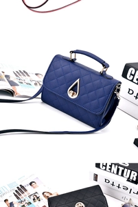 Detail showing quilted texture, drop-shaped swivel lock, and gold handles of leather bags