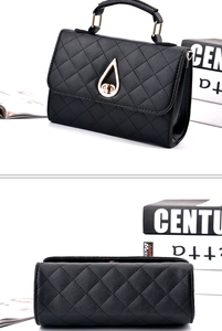 Detail of black quilted shoulder bag featuring a vintage gold teardrop-shaped twist lock