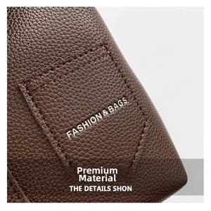 Detailed close-up of dark brown lychee grain leather handbag with neat stitching detail
