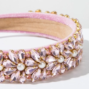 Macro detail of pink velvet headband with teardrop crystals and small white pearls