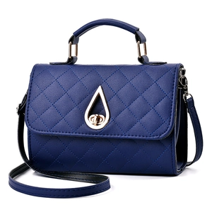 Deep blue quilted leather handbag with gold teardrop clasp and crossbody strap