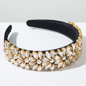 Detail of baroque headband with champagne crystals and white pearls on black velvet
