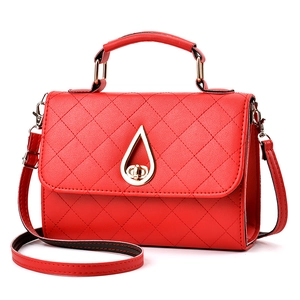 Elegant red quilted shoulder bag with golden teardrop clasp and adjustable strap