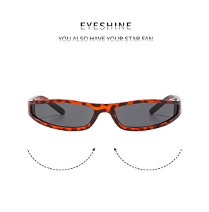 Detail of tortoise shell rectangular sunglasses with wide temples and gray lenses