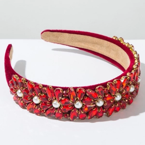 Close-up of red velvet headband with crystal flowers and white pearls for parties