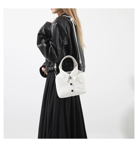 Detailed side view of a creative white shirt-shaped handbag with buttons and collar