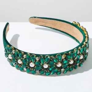 Close-up of Baroque green velvet headband with teardrop crystals and faux pearls