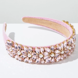 Detail of pink velvet headband with rhinestones and faux pearls in floral patterns