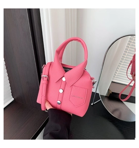 Detail of pink shirt-shaped handbag with lychee grain leather and white buttons