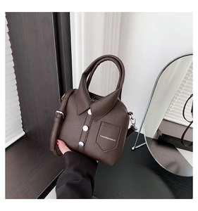 Detail of creative brown shirt-style handbag with lapel collar and silver buttons
