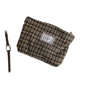 Vintage checkered cloth pouch with 'TIME TO PARTY' label and zipper closure for storage
