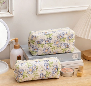 Close-up of floral quilted cotton makeup bags with diamond stitching and zipper closure