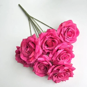 Detailed close-up of dark pink artificial roses with realistic petals and green stems