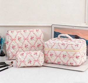 Detailed set of three floral quilted cotton cosmetic bags in various sizes and shapes