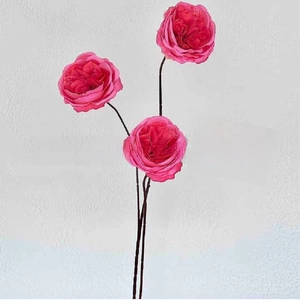 Detailed view of three long-stemmed vibrant pink silk roses with layered petals