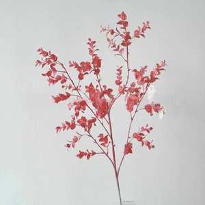 Detail of vibrant red artificial foliage stems for wedding floral arrangements and decor