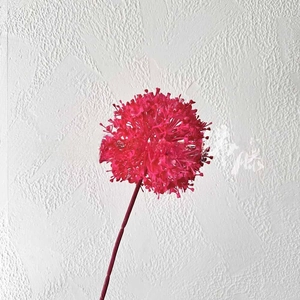 Detailed view of artificial rose pink onion ball flower with realistic textures and stem