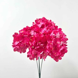 Detailed view of vibrant rose red artificial hydrangea petals with green stems for decor