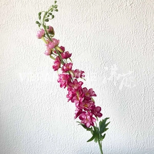 Detailed close-up of rose red artificial violet flowers with realistic petals and leaves