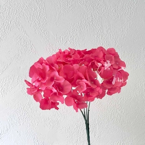 Detailed close-up of vibrant pink artificial hydrangea blossoms with realistic petals