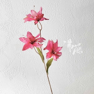 Detailed view of three pink artificial lily flower heads with natural petal gradients