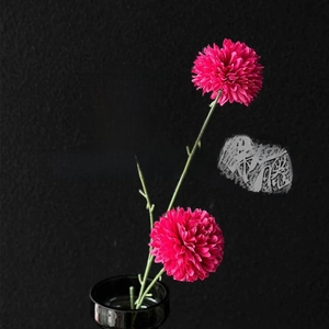 Three vibrant fuchsia artificial daisies in a sleek black glossy vase for modern home decor