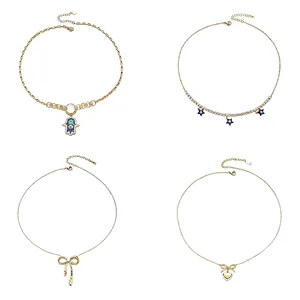 Gold titanium steel necklace set featuring butterfly, heart, and evil eye pendants