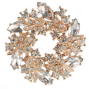 Detailed view of rose gold floral brooch with sparkling marquise-cut crystal leaves