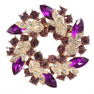 Macro detail of Bauhinia brooch featuring purple crystals and gold leaf craftsmanship