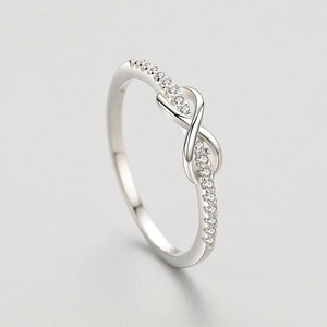 Minimalist silver infinity ring with pavé set crystals on a sleek adjustable band