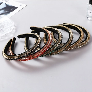 Detail of five multi-colored baroque crystal headbands with thick sponge padding and velvet
