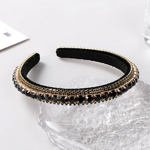 Close-up of luxury Baroque headband featuring black faceted rhinestones and gold bead chains