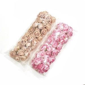 Detailed view of silk rose flower heads in cream gold and pink purple for DIY crafts