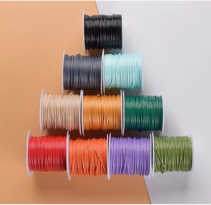 Close-up of 1.0mm colorful waxed cord spools for DIY jewelry making and crafts
