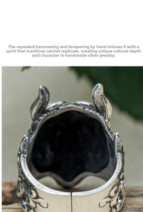 Macro shot of vintage silver ring featuring handcrafted horn totem and hammered texture