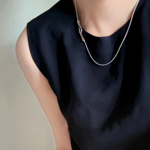 Close-up of minimalist S925 sterling silver snake bone chain necklace worn by a model