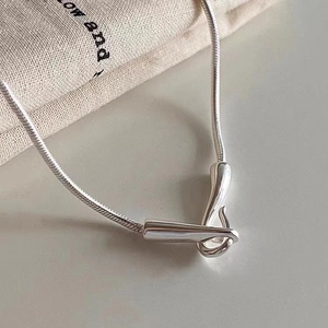 Detail shot of a polished S925 sterling silver snake chain with a sleek hook clasp