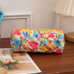 Close-up of quilted cotton cosmetic bag featuring colorful heart and bear graffiti patterns