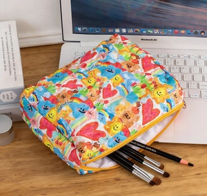 Internal view of quilted makeup bag showing large storage capacity for brushes