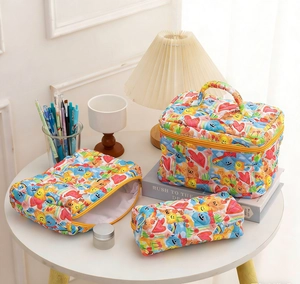 Detailed set of three colorful quilted storage bags with cute rainbow and bear patterns