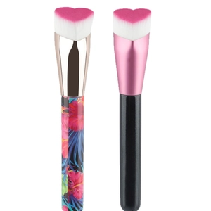 Heart-shaped foundation brush set with floral and matte black handles on white background