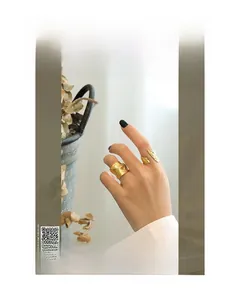 Detail of two gold irregular lava textured rings styled with vintage magazine props