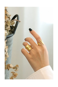 Detail shot of two gold S925 silver rings with irregular hammered textures on hands
