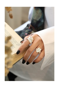 Detail of S925 sterling silver rings with irregular lava texture worn by a model