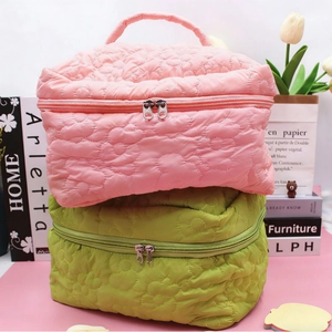Quilted floral makeup bag in pastel pink and green colors with double metal zippers