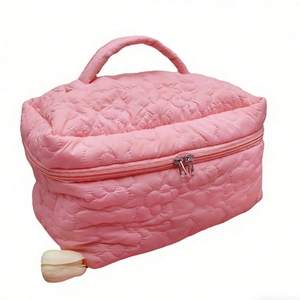 Pink quilted floral makeup bag with top handle and double zipper for travel storage