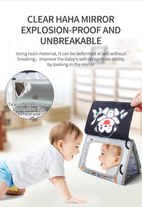 Close-up of baby cloth book with a safe resin mirror and cute monkey pattern detail