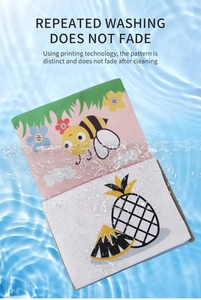 Waterproof baby cloth book showing bee and pineapple patterns in splashing blue water