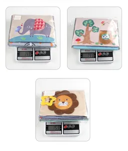 Detail showing foldable animal baby cloth books with teether on a digital scale