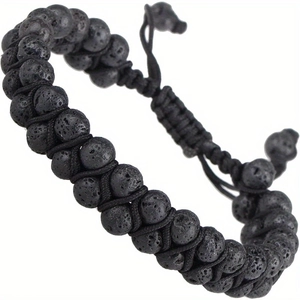 Detail showing the porous black lava stone beads and adjustable woven cord of the bracelet